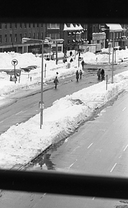 Pedestrians walking on snowy street