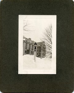 Saint Mary's Hall exterior: front with street lamp in snow, by Clifton Church