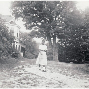 A woman walks down a path at Breezy Meadows Camp