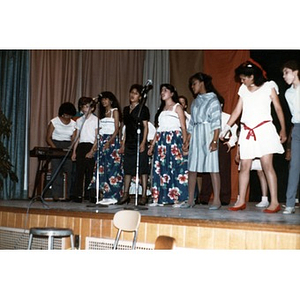 Young singers on stage.