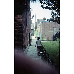 Child walking down the alley that runs alongside the ruins of the former Shawmut Congregational Church.