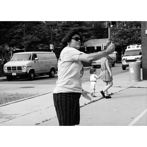 Woman in sunglasses gesturing.