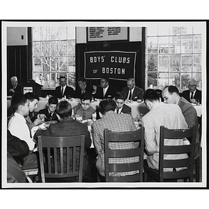 Boys and men sit together and eat at a Boys' Clubs of Boston awards event