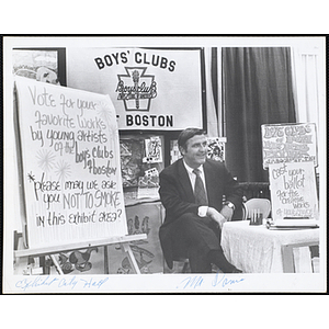 Frederick J. Davis sits at the Boys' Clubs of Boston Fine Arts Exhibit at the City Hall