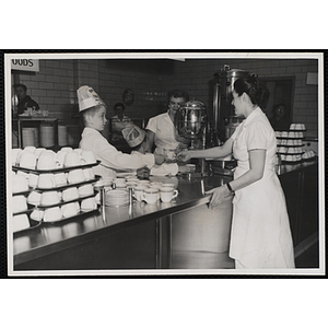 A member of the Tom Pappas Chefs' Club assists staff with coffee service in the Hanscom Air Force Base restaurant