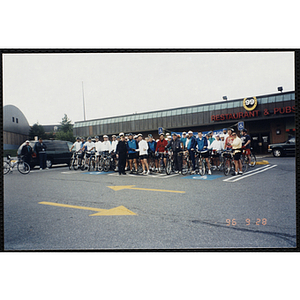 Riders pose for a large group shot with their bicylces in a parking lot for the Charlestown Bike Race