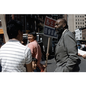 Mel King speaks with people on a street during the August Moon Festival in Boston's Chinatown
