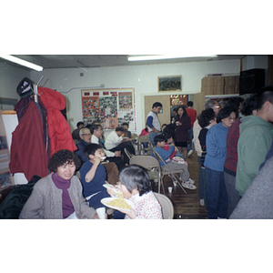 Adults and children attend a Chinese Progressive Association holiday party