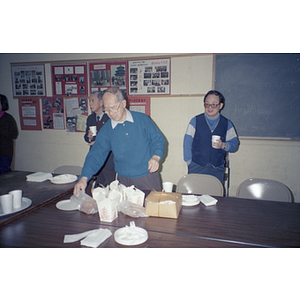 Members take food at a Chinese Progressive Association event