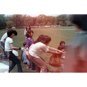 Game of tug-of-war at a tutoring class picnic