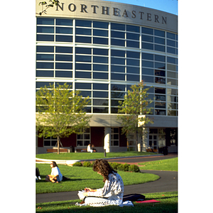 Student reading in Centennial Circle