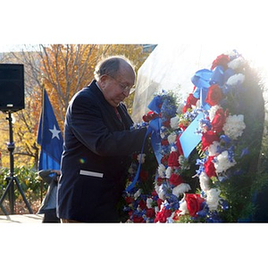 A man places a wreath on the Veterans Memorial at the dedication ceremony
