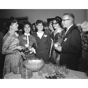 Four women with a man at a Freshman Tea reception
