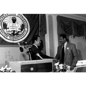 Richard Lapchick shakes hands with Rev. Jesse Jackson