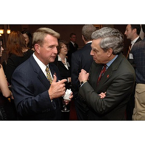 Charles J. Hoff, Outstanding Alumni Award recipient and member of the Board of Overseers, converses with President Richard Freeland, right, at the Alumni Ball and Alumni Awards Ceremony