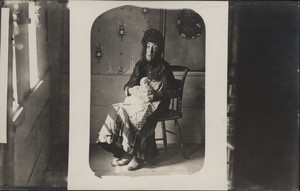 Full-length portrait of Nancy Luce, seated, facing front, holding her pet hen, West Tisbury, Mass., undated