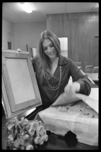 Judy Collins unwrapping a painting