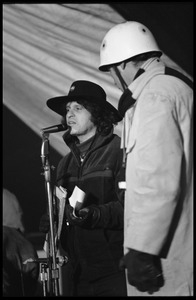 Paul Krassner (left) speaking to the audience at the Counter-inaugural ball, 1969