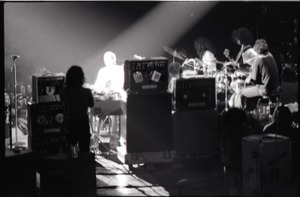 Santana concert at the Springfield Civic Center: view of band and audience from behind bank of audio equipment