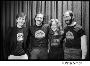 Musicians United for Safe Energy concert performers: Graham Nash, James Taylor, Bonnie Raitt, and John Hall (l. to r.) wearing MUSE tee-shirts