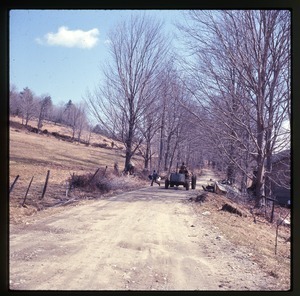 Riding a tractor down the road while sugaring, Montague Farm Commune