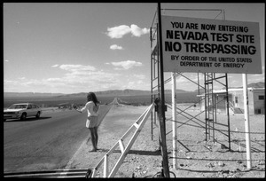 Peace encampment activist waving at automobile leaving the Nevada Test Site