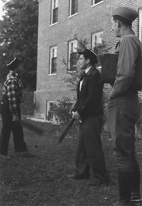 Edmund Freitas, Sydney Zeitler and Edward Podolak outside a dormitory