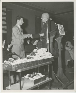 Unidentified staff shaking hands with client at Institute Day