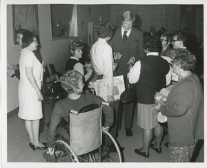 Actor Ken Howard signing autographs for clients at Thanksgiving celebration