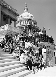 Group of visitors, posed on the steps of the United States Capitol building