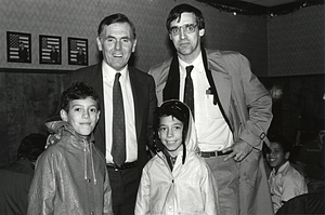 Mayor Raymond L. Flynn, author and Mission Hill Little League President Jim Vrabel and Carlos and Manuel Rodriguez of the Mission Hill Indians Little League baseball team at the Fall Mission Hill LIttle League banquet in Mission Hill School Hall