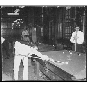 Young men playing pool