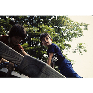 Boys climbing an outdoor play structure