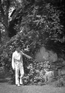 A man stands outside Lodestone, Charles Eastman's residence in Amherst, Massachusetts