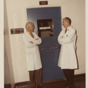 Dr. Murray and Dr. Tessier standing in front of the Plastic Surgery Unit at Children's Hospital