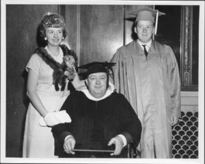 Graduate with faculty and family at the 1965 Suffolk University commencement