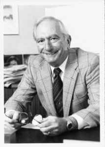 Suffolk University Dean Paul R. Sugarman (Law, 1989-1994), seated behind desk