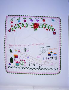 Cotton cloth embroidered with flowers and a scene of soldiers and a helicopter attacking a village by a river