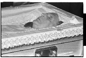 Eamon De Valera, President of Ireland. Close-up shot of De Valera lying in state in his coffin in Dublin Castle and shot of people outside Dublin Castle (including a TV camera-man) getting ready for the funeral