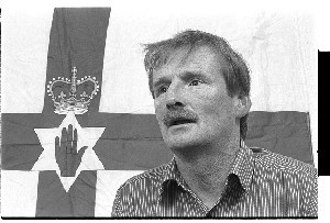 Sammy Duddy, UDA leader, loyalist poet. Taken at the UDA Headquarters in Belfast, standing in front of the Ulster flag