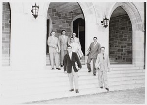 Boston College students pose for portrait on the steps of a campus building