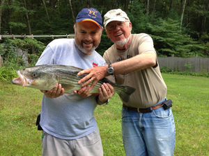 Tom E. and Tom J. with a striped bass from the Essex River