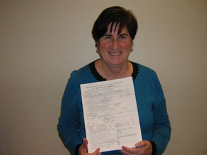 Janis Duffy holding the Foresters application for her great-great-grandmother's brother, Michael Dillon