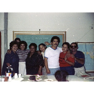 Group photo of five female and three male staff workers at a party at La Alianza Hispana, Boston.