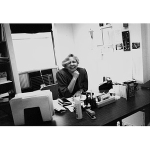 Woman sitting at her desk in her office.