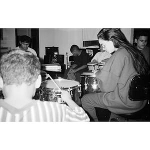 Young drummers participate in an Areyto class.