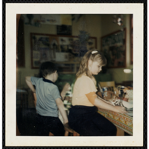 A boy and a girl working on projects for their art class at the South Boston Boys' Club