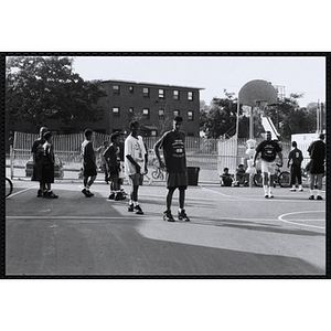 Players perform warm-up drills during a Chelsea Housing Authority Basketball League game