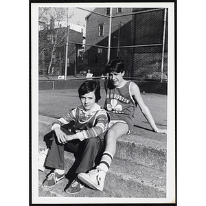 Two boys sit outside at the South Boston Clubhouse