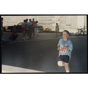 A boy runs in the Battle of Bunker Hill Road Race